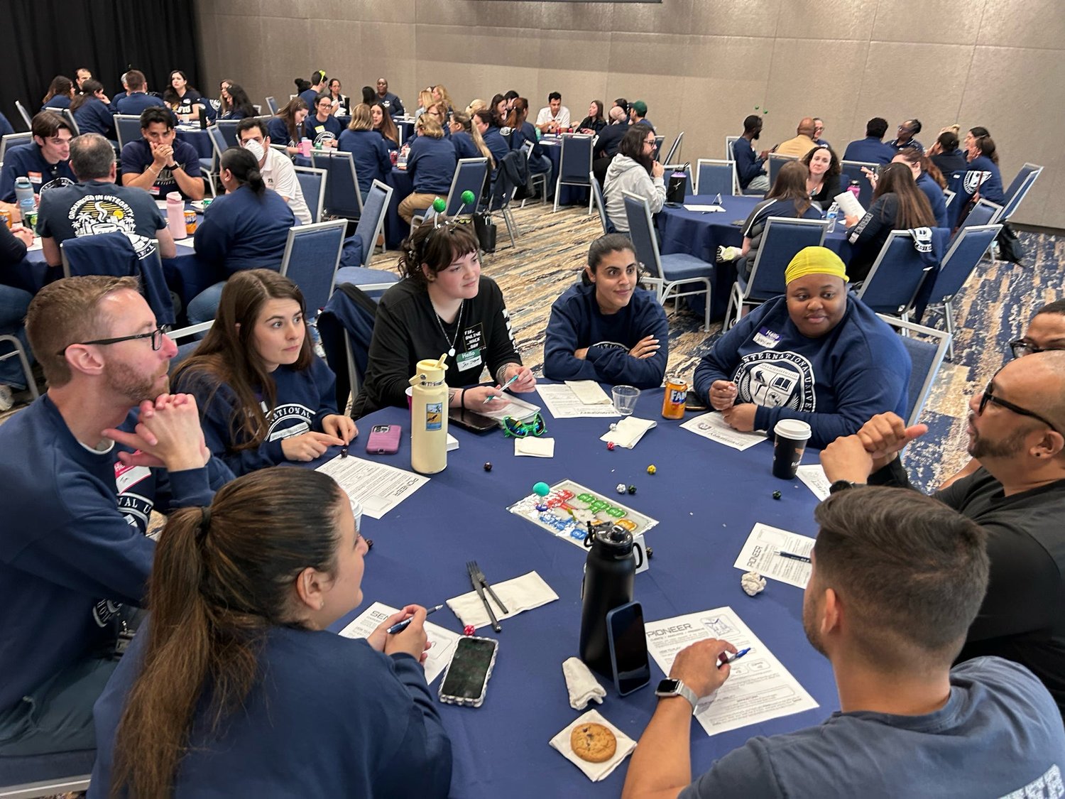 A packed room of players at the Mission: Zorbitron tables